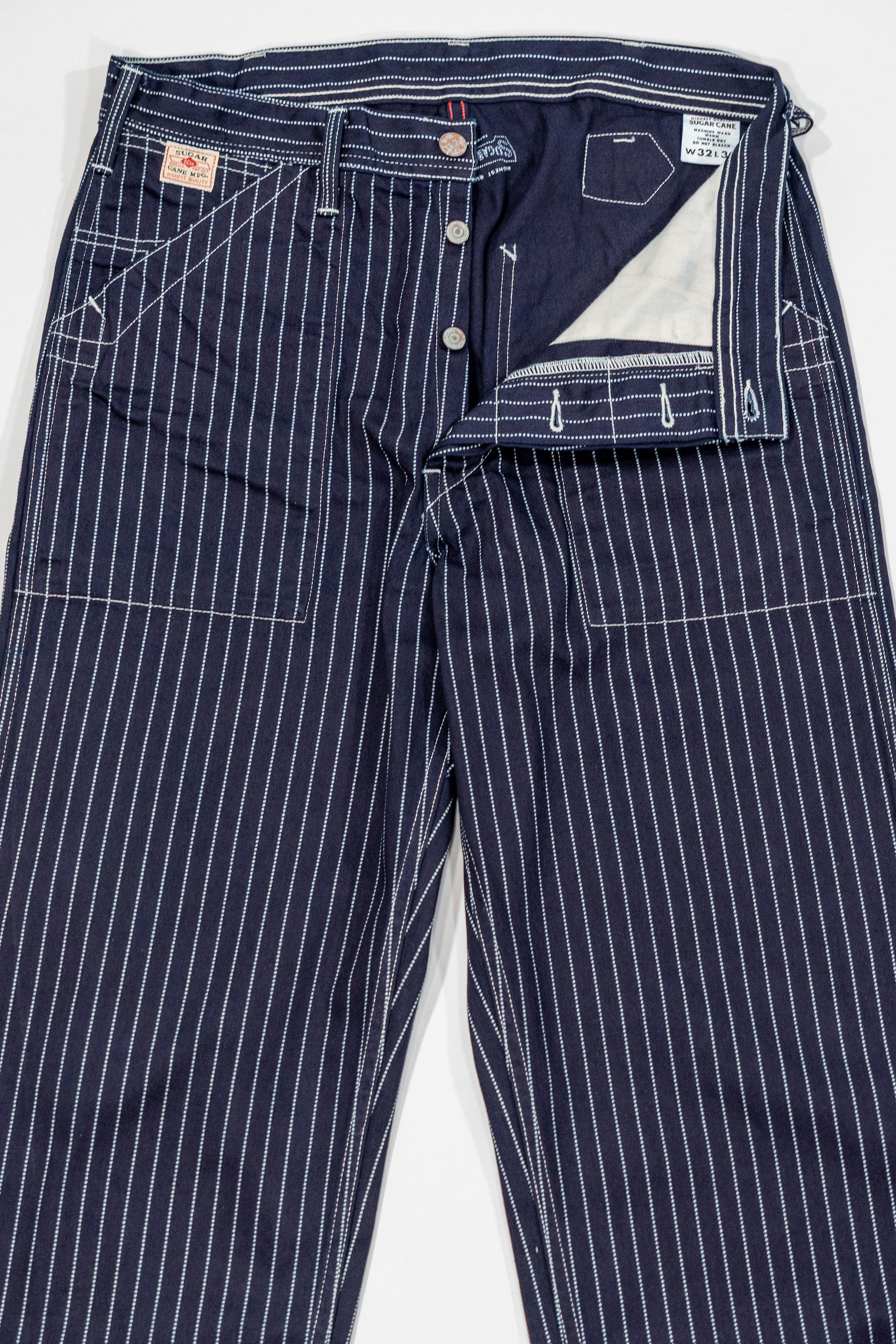Navy striped fatigue pocket pants front view open fly laying flat