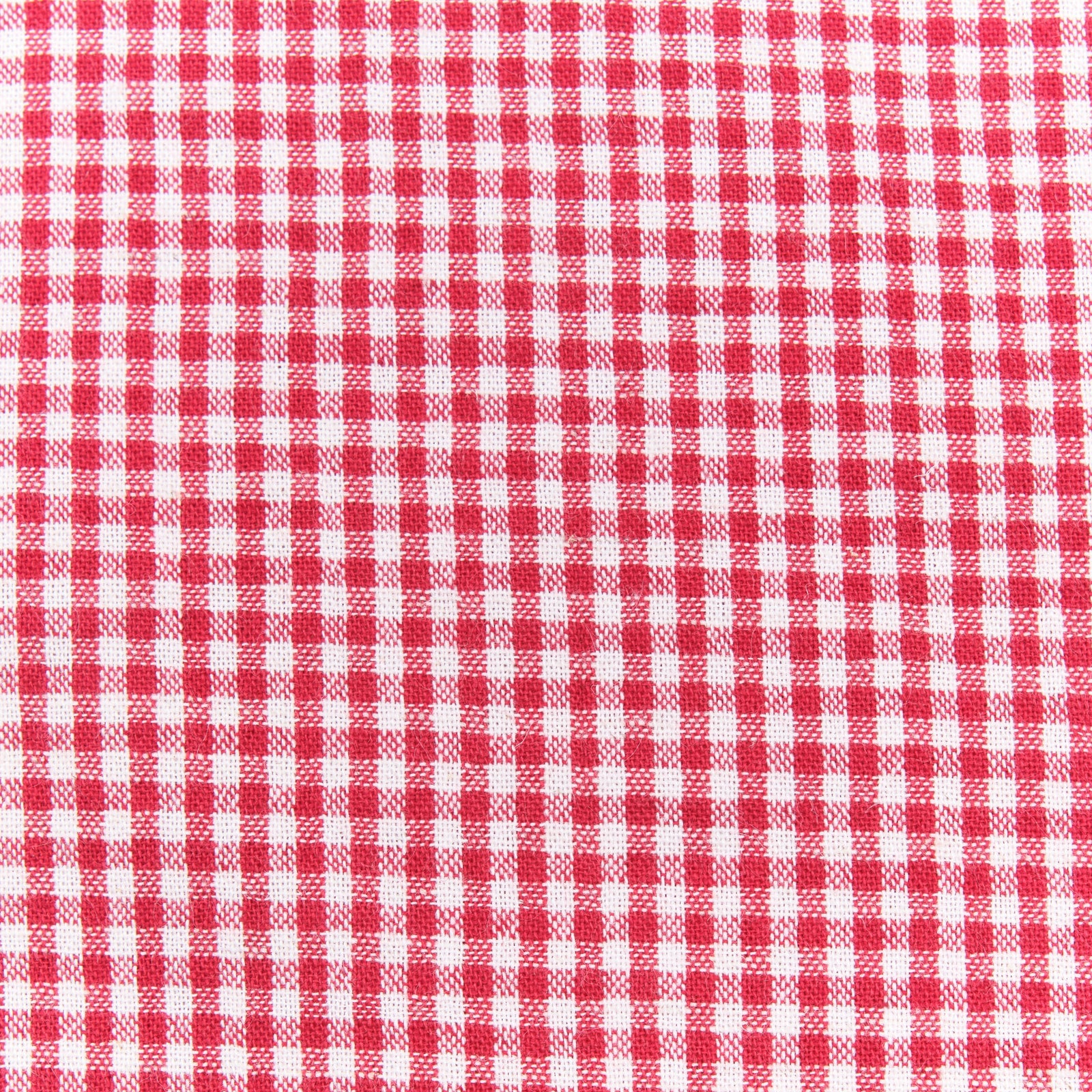 Red and white gingham western-style button-down shirt close up on fabric