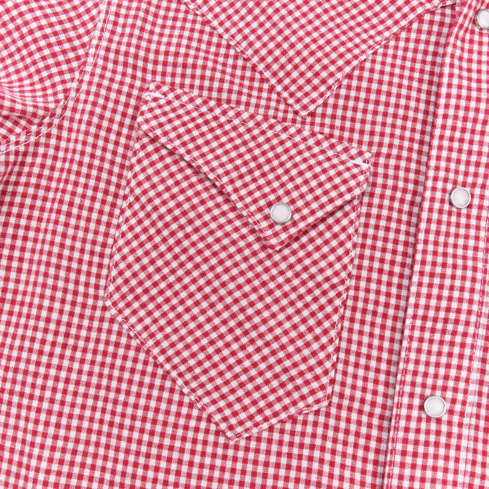 Red and white gingham western-style button-down shirt close up on right chest pocket laying flat