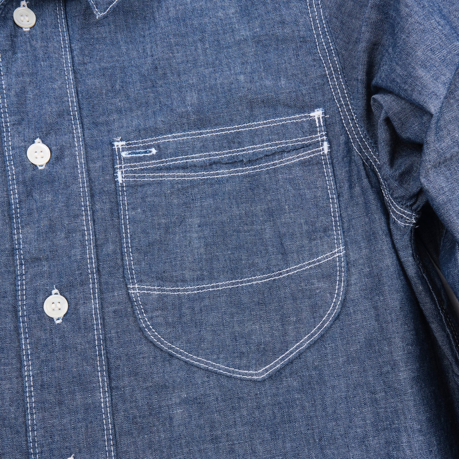 Shirt laid flat, from the front. Close up on left chest pocket. 