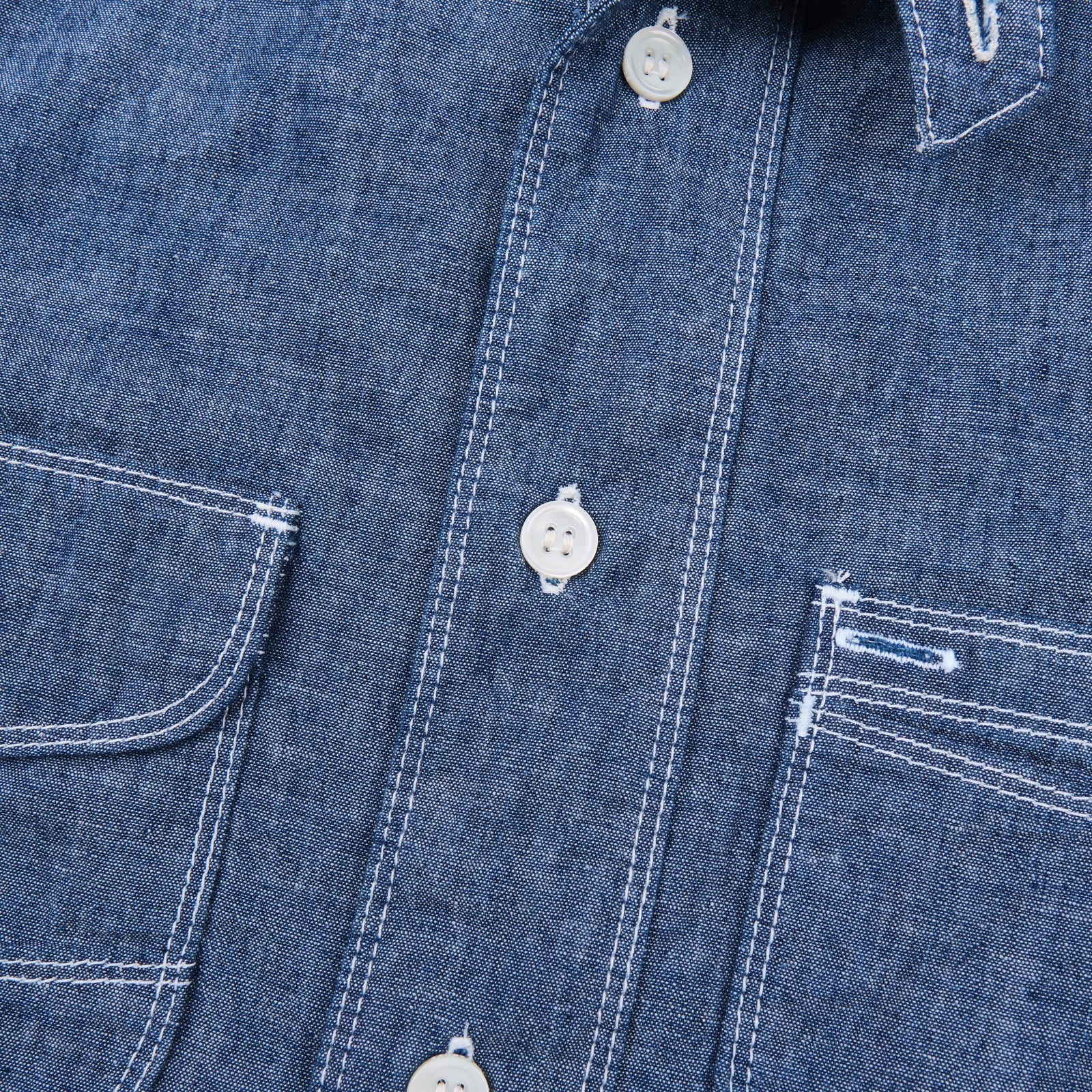 Shirt laid flat on white, from the front. Close up on buttons.