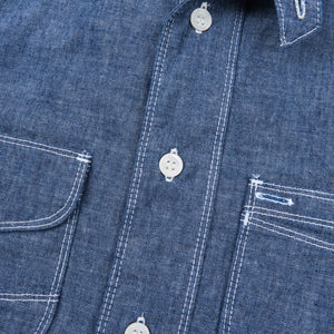 Shirt laid flat on white, from the front. Close up on buttons.