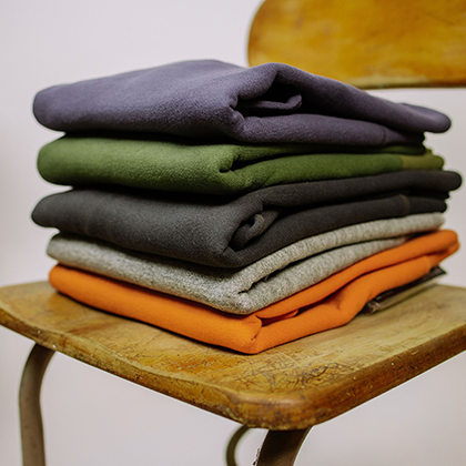 Stack of folded knitwear in various colors
