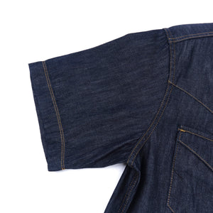 Dark indigo denim western-style short sleeve shirt with white snaps, close up sleeve hem laying flat