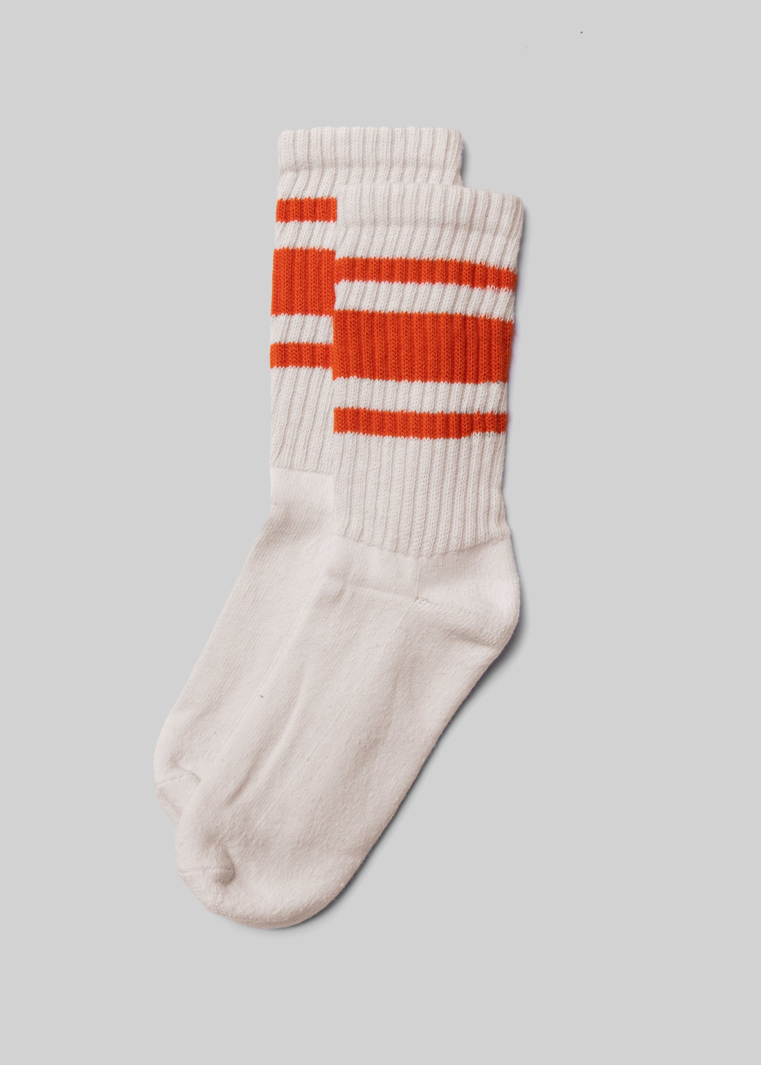 American Trench Retro Mono Sock in natural white with orange stripes laid flat